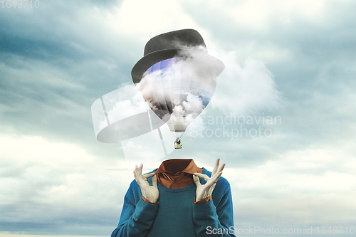 Image of Contemporary art collage. Male body of model with head full of smoke about sky and clouds.