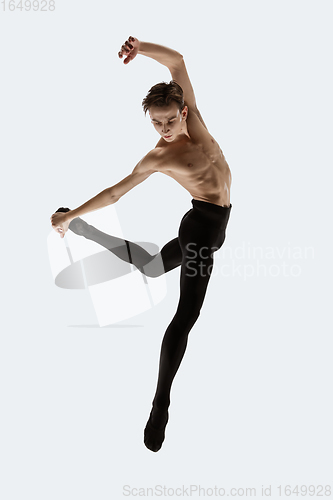 Image of Young and graceful ballet dancer in minimal black style isolated on white studio background