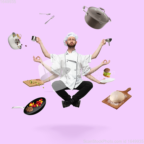 Image of Handsome multi-armed chief-cooker levitating isolated on pink studio background with equipment. Multitask concept.