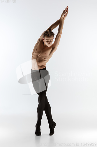 Image of Young and graceful ballet dancer in minimal black style isolated on white studio background