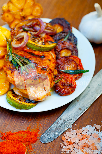 Image of roasted grilled BBQ chicken breast with herbs and spices