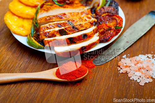 Image of roasted grilled BBQ chicken breast with herbs and spices