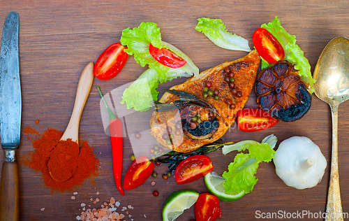 Image of wood fired hoven cooked chicken breast on wood board