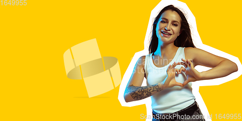 Image of Portrait of happy young woman posing isolated on yellow background. Collage in magazine style. Flyer for ad, design.