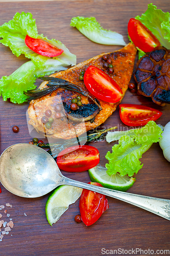 Image of wood fired hoven cooked chicken breast on wood board