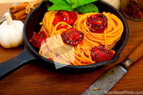 Image of italian spaghetti pasta and tomato with mint leaves