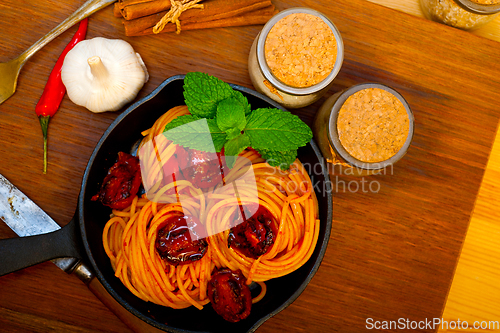 Image of italian spaghetti pasta and tomato with mint leaves