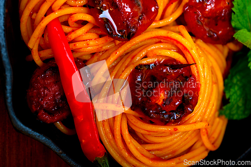 Image of italian spaghetti pasta and tomato with mint leaves