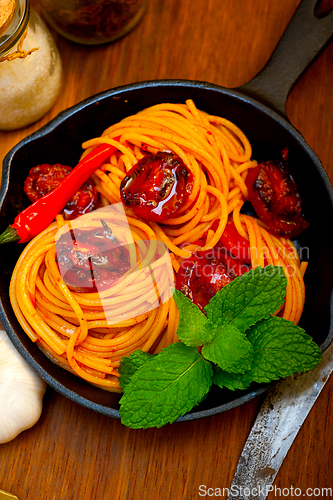 Image of italian spaghetti pasta and tomato with mint leaves