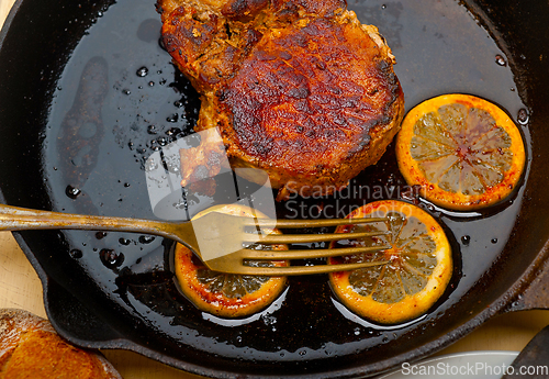 Image of pork chop seared on iron skillet