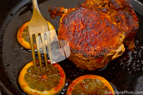 Image of pork chop seared on iron skillet