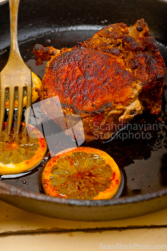 Image of pork chop seared on iron skillet