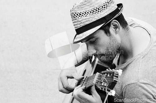 Image of Man plays the guitar