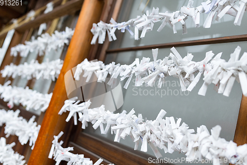 Image of Paper strips with random fortunes in Japanese temple