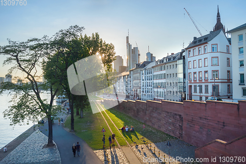 Image of People relaxing city embankment Frankfurt