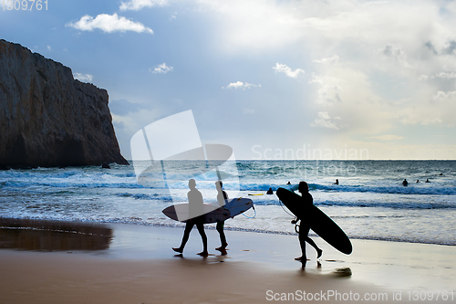 Image of Group surfers surfboards beach Portugal