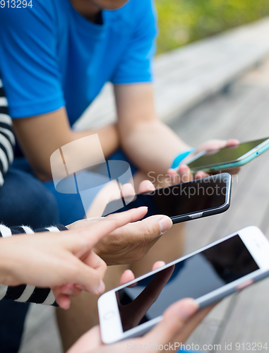 Image of Friends using cellphone together