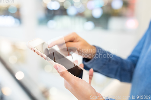 Image of Woman working on cellphone