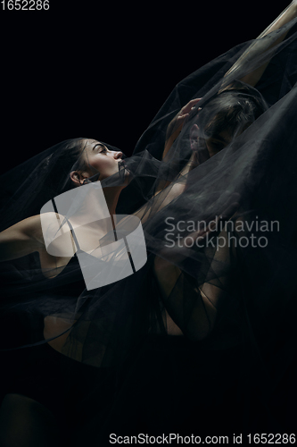 Image of Graceful classic ballet dancers isolated on black studio background. The grace, artist, movement, action and motion concept.