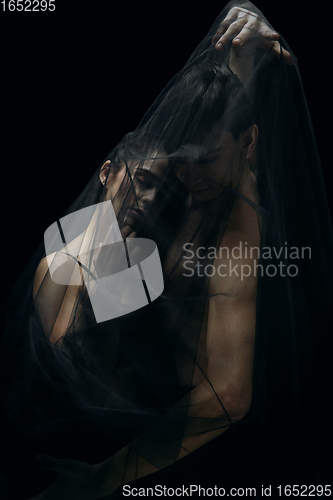 Image of Graceful classic ballet dancers isolated on black studio background. The grace, artist, movement, action and motion concept.