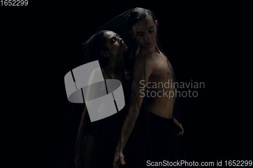 Image of Graceful classic ballet dancers isolated on black studio background. The grace, artist, movement, action and motion concept.