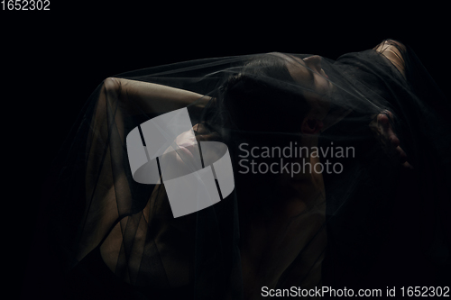 Image of Graceful classic ballet dancers isolated on black studio background. The grace, artist, movement, action and motion concept.