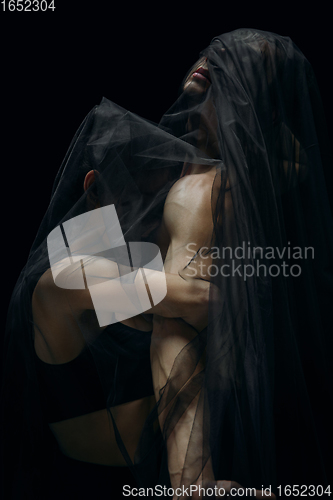 Image of Graceful classic ballet dancers isolated on black studio background. The grace, artist, movement, action and motion concept.