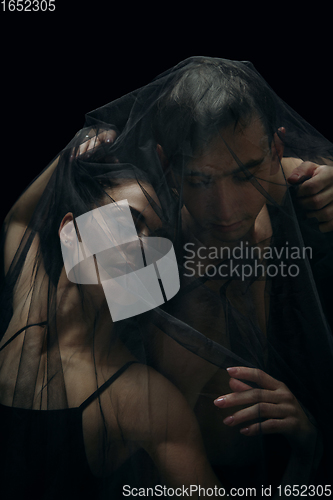 Image of Graceful classic ballet dancers isolated on black studio background. The grace, artist, movement, action and motion concept.