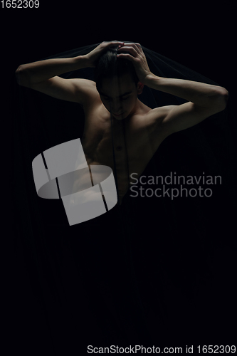 Image of Graceful classic ballet dancer dancing isolated on dark studio background. The grace, artist, movement, action and motion concept.