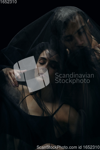 Image of Graceful classic ballet dancers isolated on black studio background. The grace, artist, movement, action and motion concept.