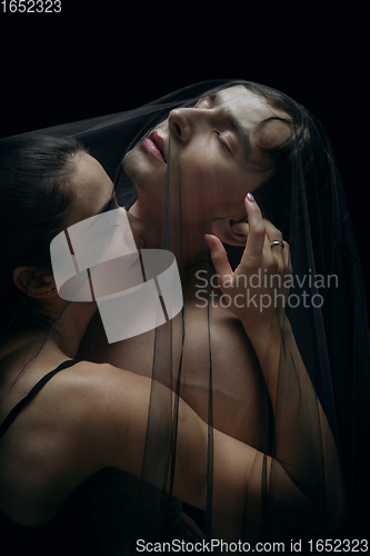 Image of Graceful classic ballet dancers isolated on black studio background. The grace, artist, movement, action and motion concept.