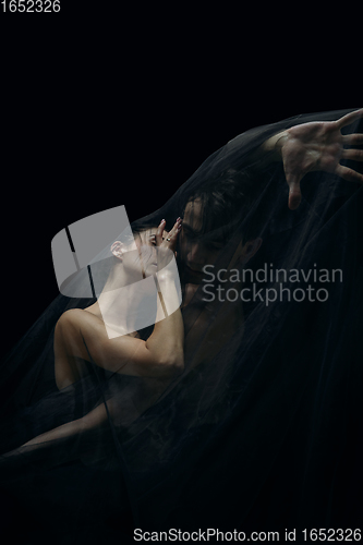 Image of Graceful classic ballet dancers isolated on black studio background. The grace, artist, movement, action and motion concept.