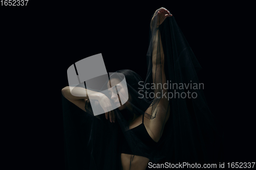 Image of Graceful classic female ballet dancer isolated on black studio background. The grace, artist, movement, action and motion concept.