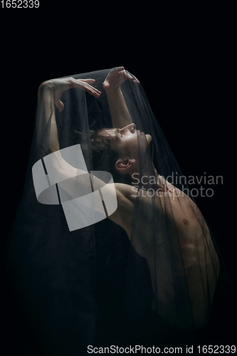 Image of Graceful classic ballet dancer dancing isolated on dark studio background. The grace, artist, movement, action and motion concept.