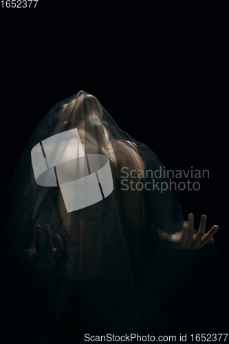 Image of Graceful classic ballet dancer dancing isolated on dark studio background. The grace, artist, movement, action and motion concept.