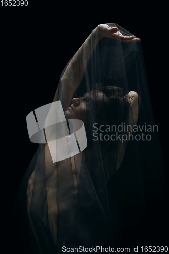 Image of Graceful classic ballet dancer dancing isolated on dark studio background. The grace, artist, movement, action and motion concept.