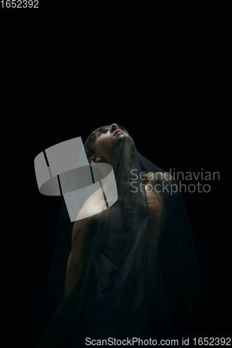 Image of Graceful classic ballet dancer dancing isolated on dark studio background. The grace, artist, movement, action and motion concept.