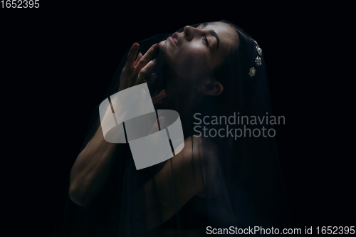 Image of Graceful classic female ballet dancer isolated on black studio background. The grace, artist, movement, action and motion concept.