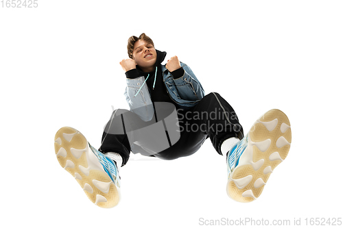 Image of Young stylish man in modern street style outfit isolated on white background, shot from the bottom