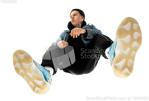 Image of Young stylish man in modern street style outfit isolated on white background, shot from the bottom