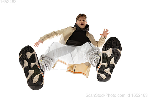 Image of Young stylish man in modern street style outfit isolated on white background, shot from the bottom
