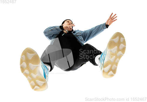 Image of Young stylish man in modern street style outfit isolated on white background, shot from the bottom