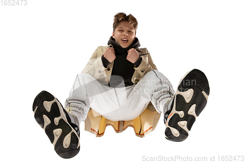 Image of Young stylish man in modern street style outfit isolated on white background, shot from the bottom