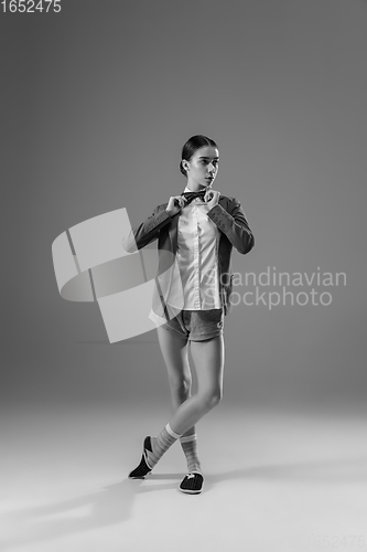 Image of Young fashionable, stylish woman wearing jacket and socks working from home. Fashion during insulation \'cause of coronavirus pandemic