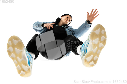 Image of Young stylish man in modern street style outfit isolated on white background, shot from the bottom