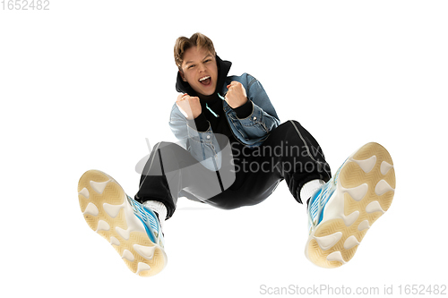 Image of Young stylish man in modern street style outfit isolated on white background, shot from the bottom