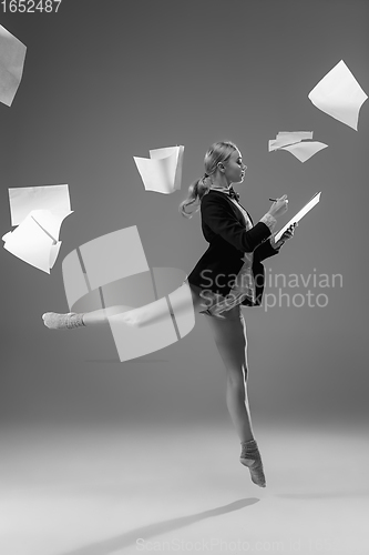 Image of Young fashionable, stylish woman wearing jacket and socks working from home. Fashion during insulation \'cause of coronavirus pandemic