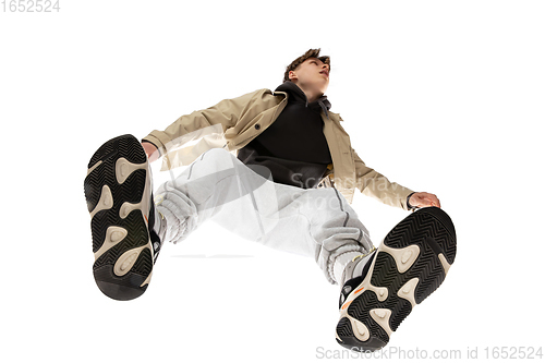 Image of Young stylish man in modern street style outfit isolated on white background, shot from the bottom