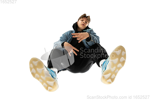 Image of Young stylish man in modern street style outfit isolated on white background, shot from the bottom