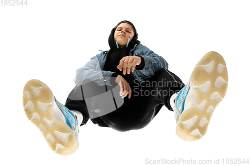 Image of Young stylish man in modern street style outfit isolated on white background, shot from the bottom